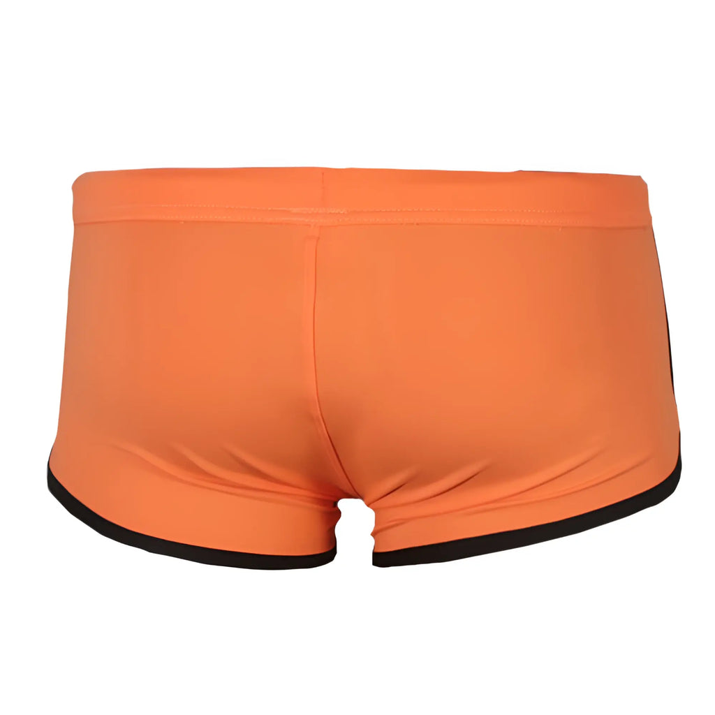 Bright orange pride vince trunk swim trunks with black trim along waistband and leg openings for swimming