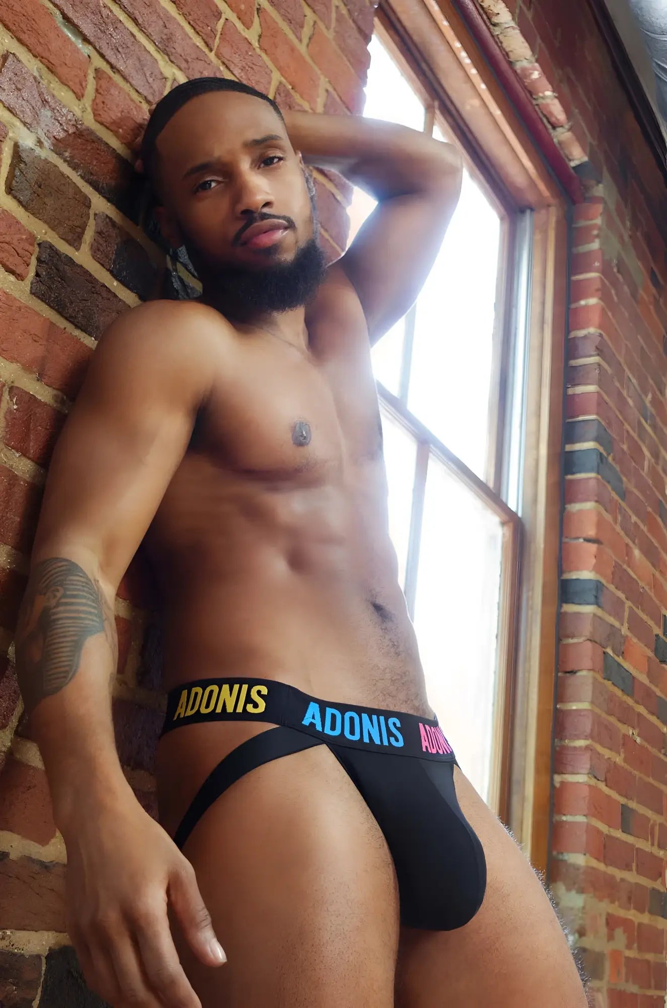 Black adonis pride365 jockstrap briefs with bold yellow and pink logo band for supportive comfortable wear