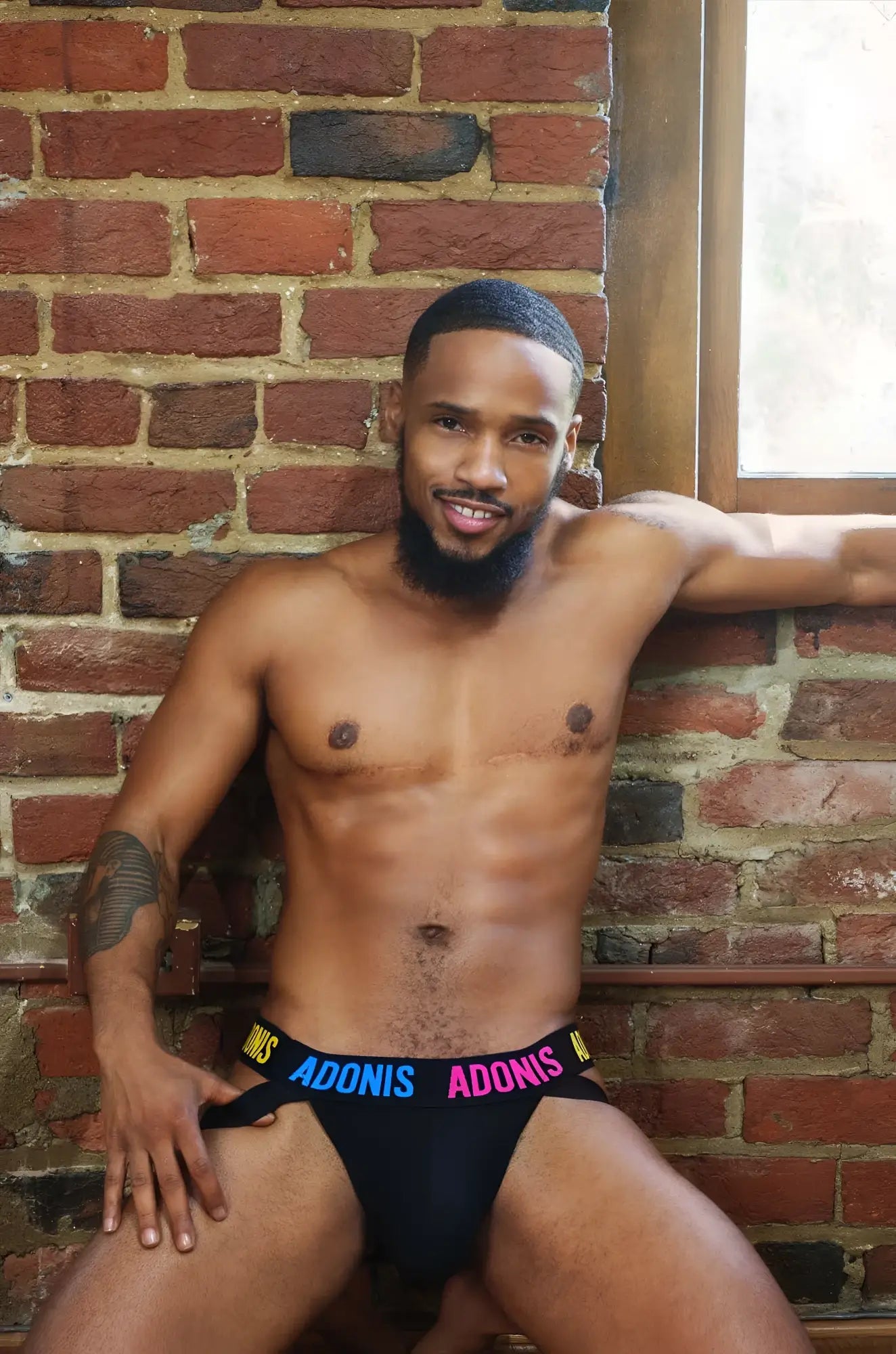 Black pride365 jockstrap briefs with adonis printed in blue and pink on the waistband