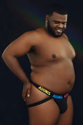 Black pride365 jockstrap briefs with adonis printed in yellow and blue lettering on the front
