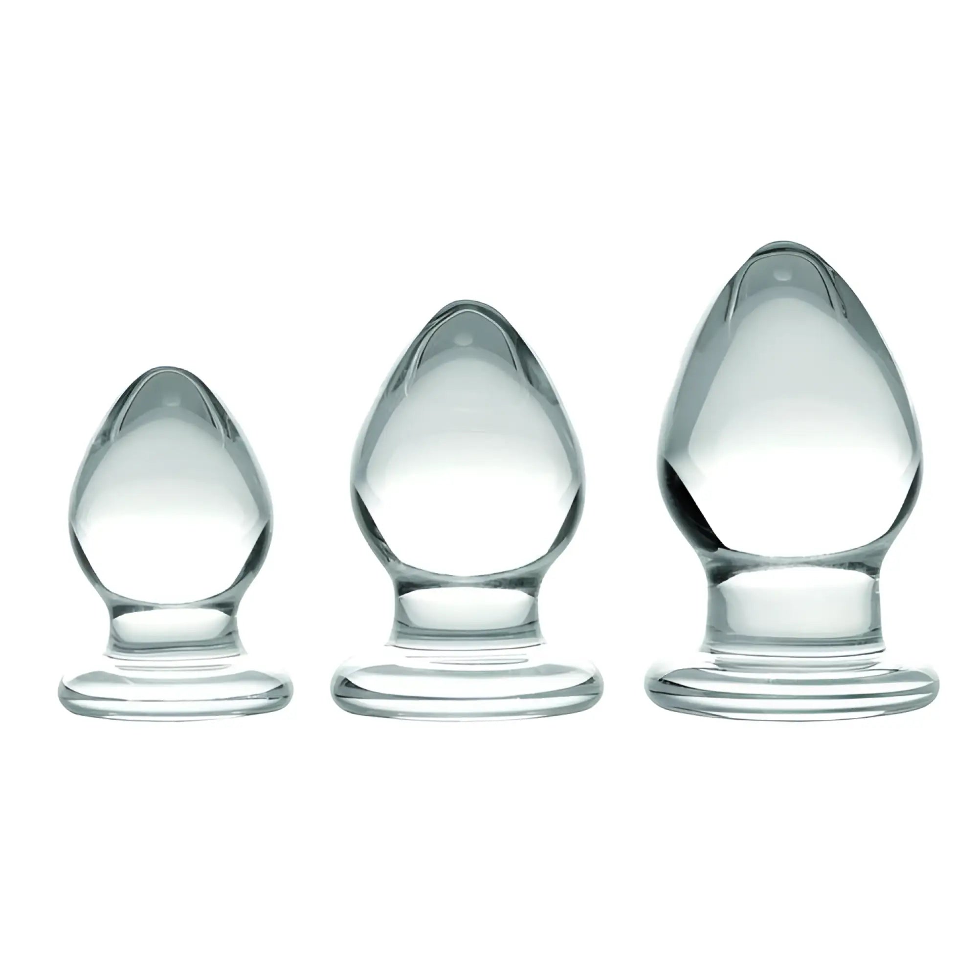 Prisms Erotic Glass 3 Piece Anal Plug Kit featuring three graduated, smooth, clear glass plugs on a white background.