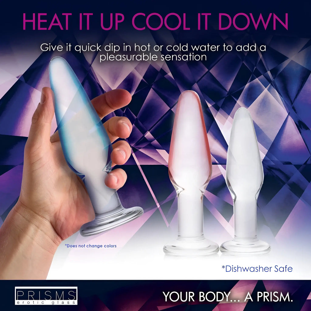 Prisms Erotic Glass 3pc Dosha Anal Plug Kit: three clear, smooth glass plugs in varying sizes held by a hand.
