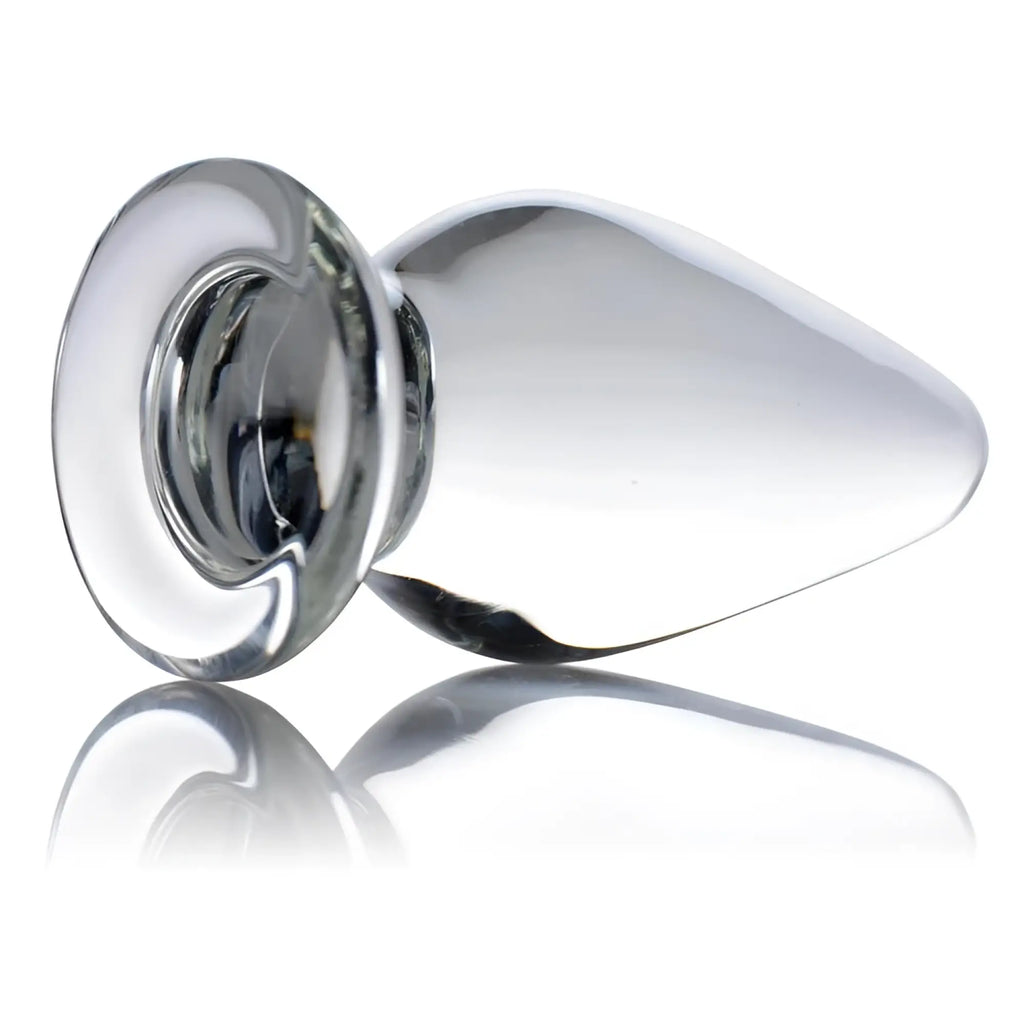Prisms Erotic Glass Ember weighted tapered anal plug in clear glass with a wide base, set against a white background.