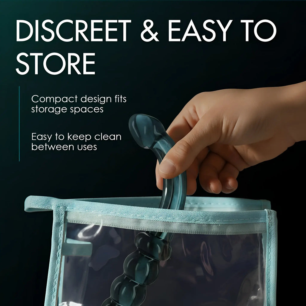 A hand placing a smoky jade, curved glass Prisms Erotic dildo into a small, clear storage bag.