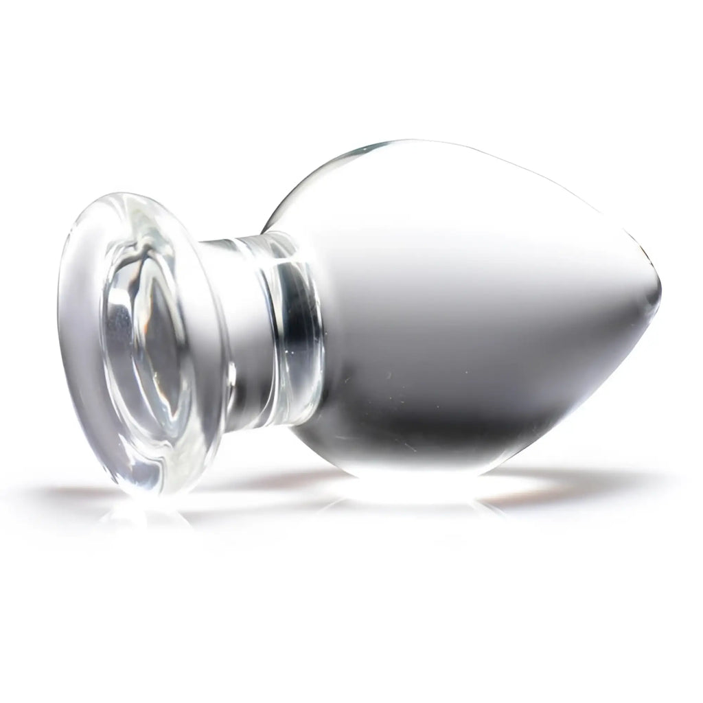 Prisms Erotic clear glass butt plug with a smooth, bulbous shape and a wide, flared base against a white background.