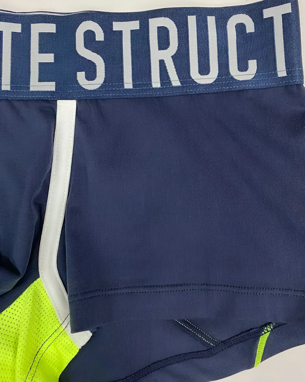 Navy blue athletic briefs with white and neon green accents and bold struct waistband logo by private structure