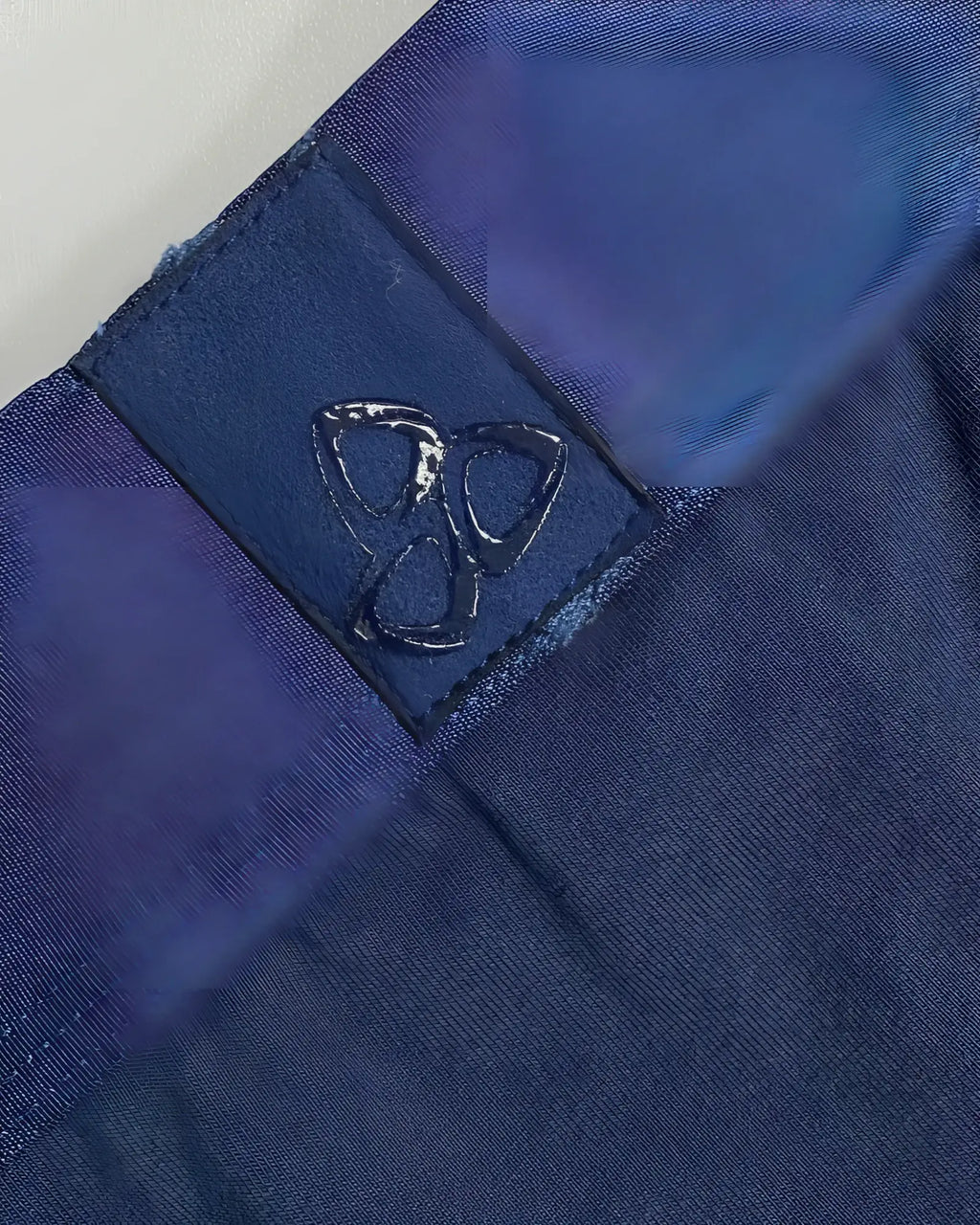 Dark blue fabric patch with glossy embossed logo stitched on private structure baut4389 athlete trunks navy ranger
