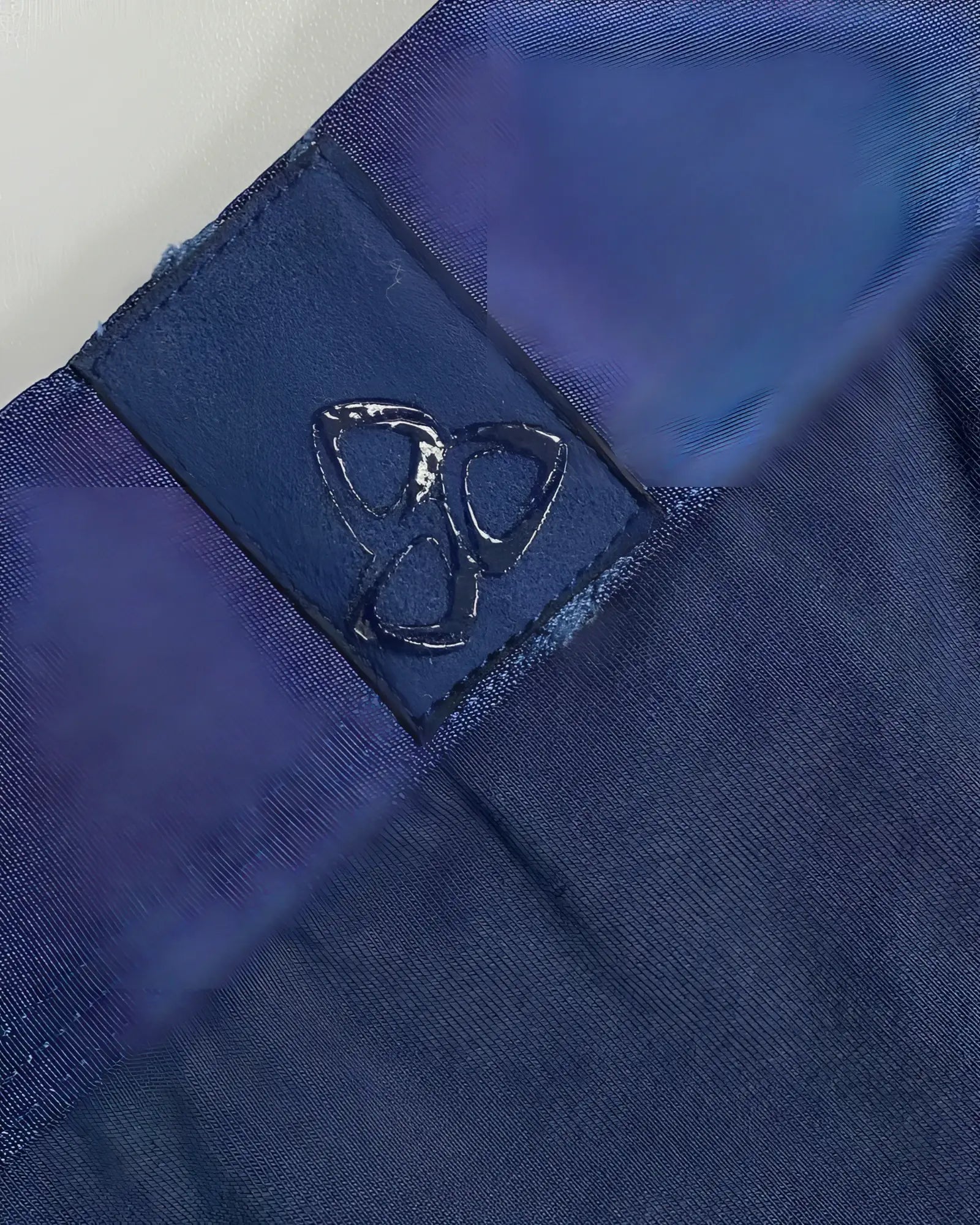 Dark blue fabric patch with glossy embossed logo stitched on private structure baut4389 athlete trunks navy ranger