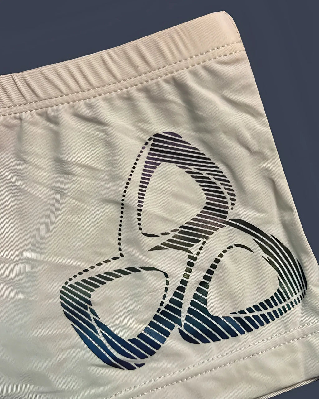 Cream-colored fabric shorts with bold blue and black biohazard symbol printed on front from private structure br4380 bare hipster