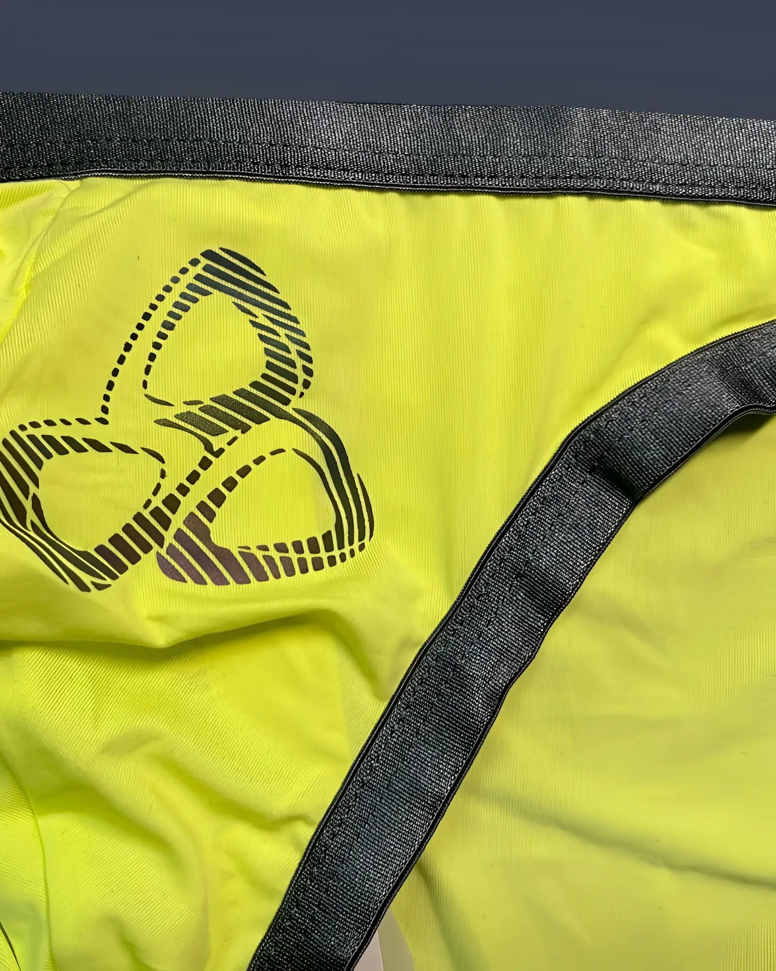Bright yellow Private Structure BRUT4393 bare bikini briefs with black three-leaf logo and dark gray elastic waistband