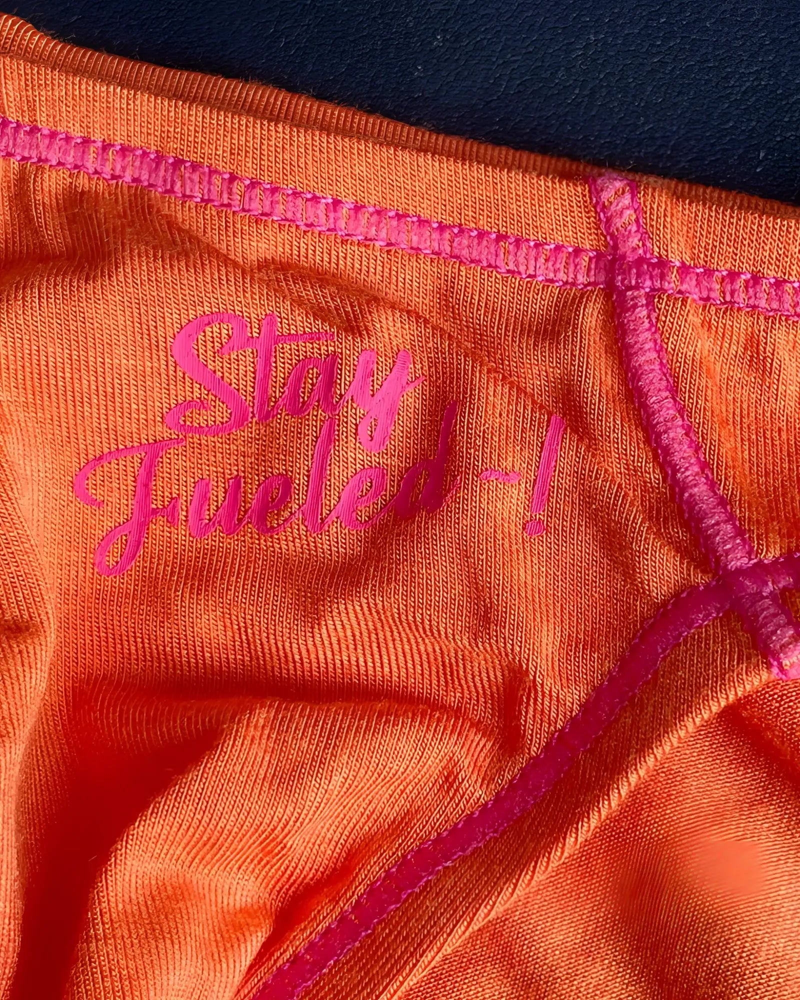 Orange Private Structure EPUS4563 Prime Eutopia bikini brief with pink embroidered text and matching stitching in tangerine