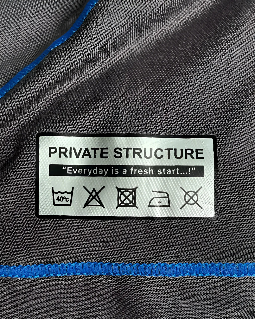 Gray fabric with blue stitching and white private structure care label on private structure epus4570 prime elysian hipster