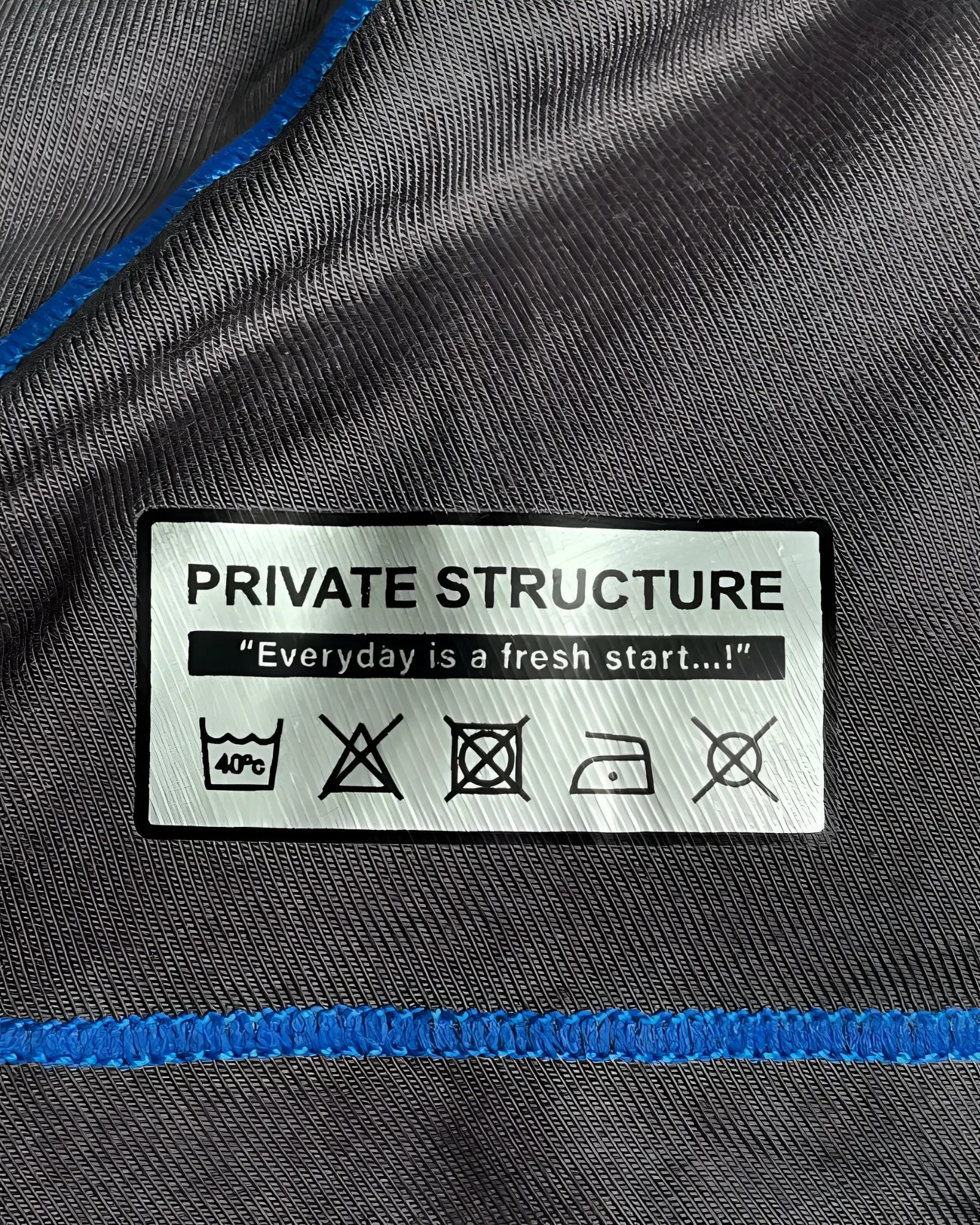 Gray fabric with blue stitching and white private structure care label on private structure epus4570 prime elysian hipster