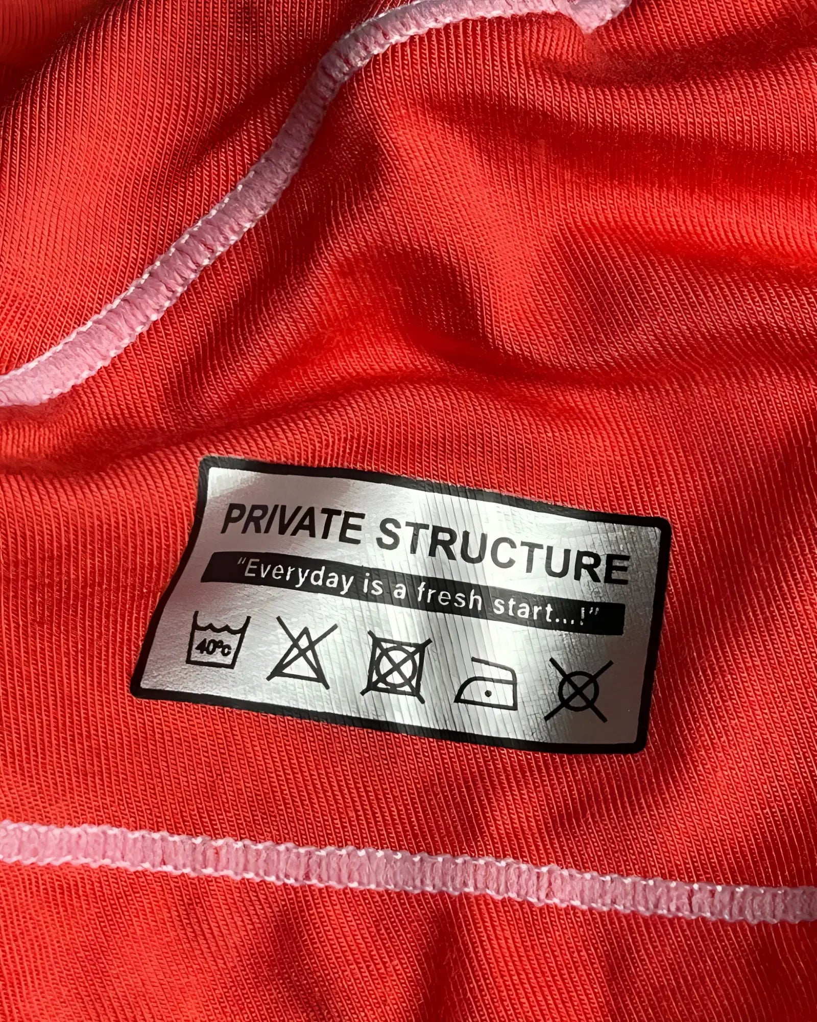 Back silver rectangular care label with black text on red private structure epus4570 prime elysian hipster underwear