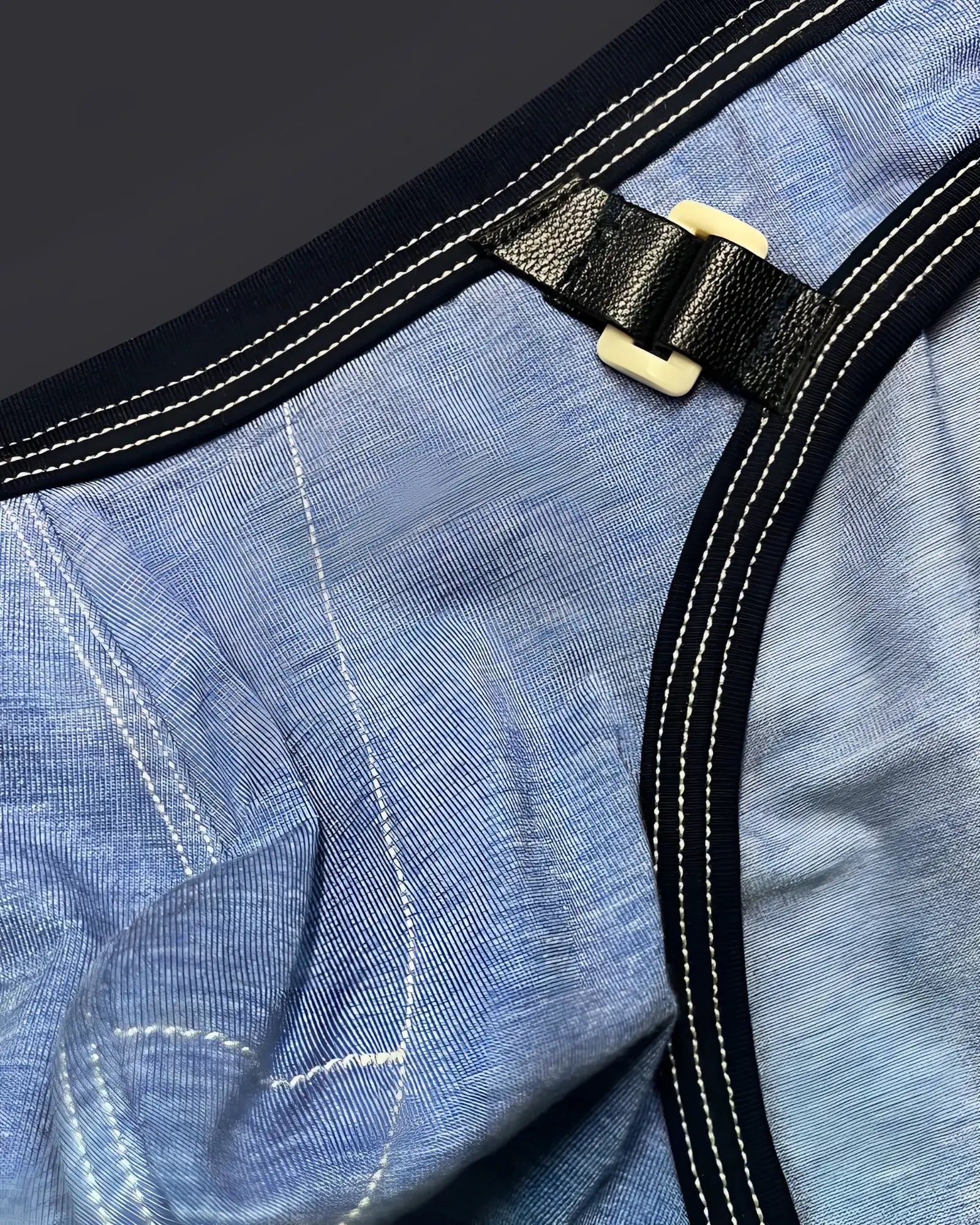 Black leather strap with cream plastic buckle attached to denim fabric on private structure lcut4358 barn boy low rise mini brief