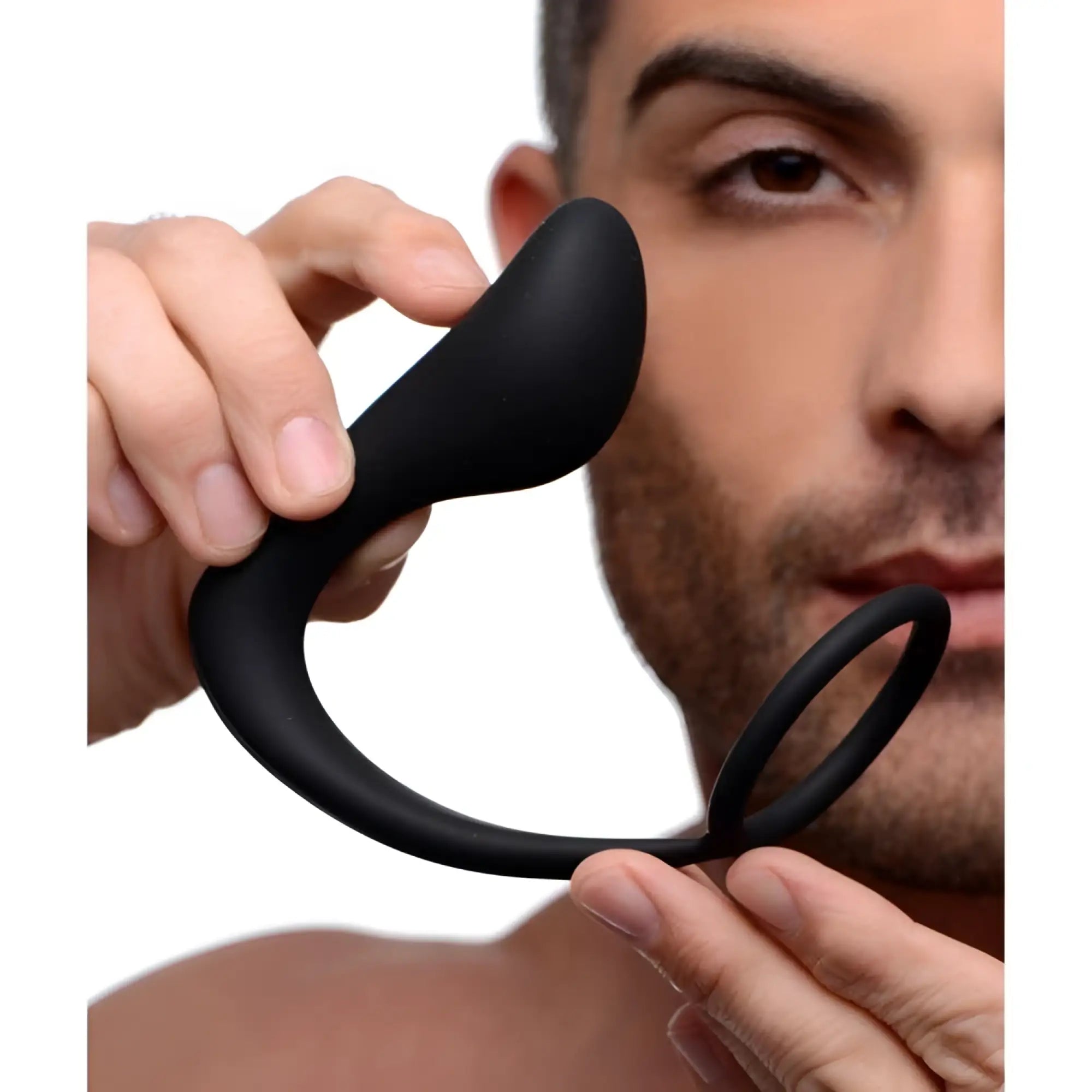 A person holding the black, ergonomic Prostatic Play Explorer II prostate stimulator and integrated cock ring.