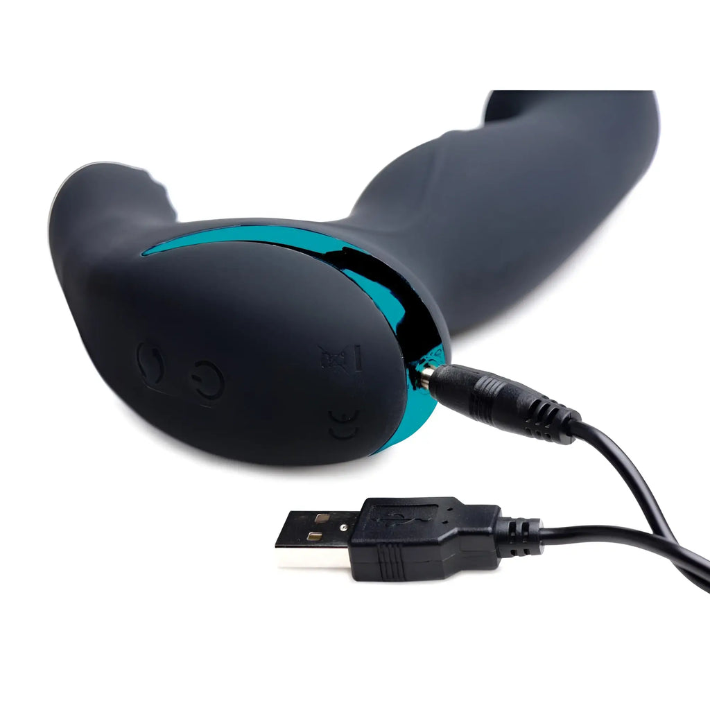 Matte black Prostatic Play Mega Maverick stimulator with teal accents being charged with a USB cable.