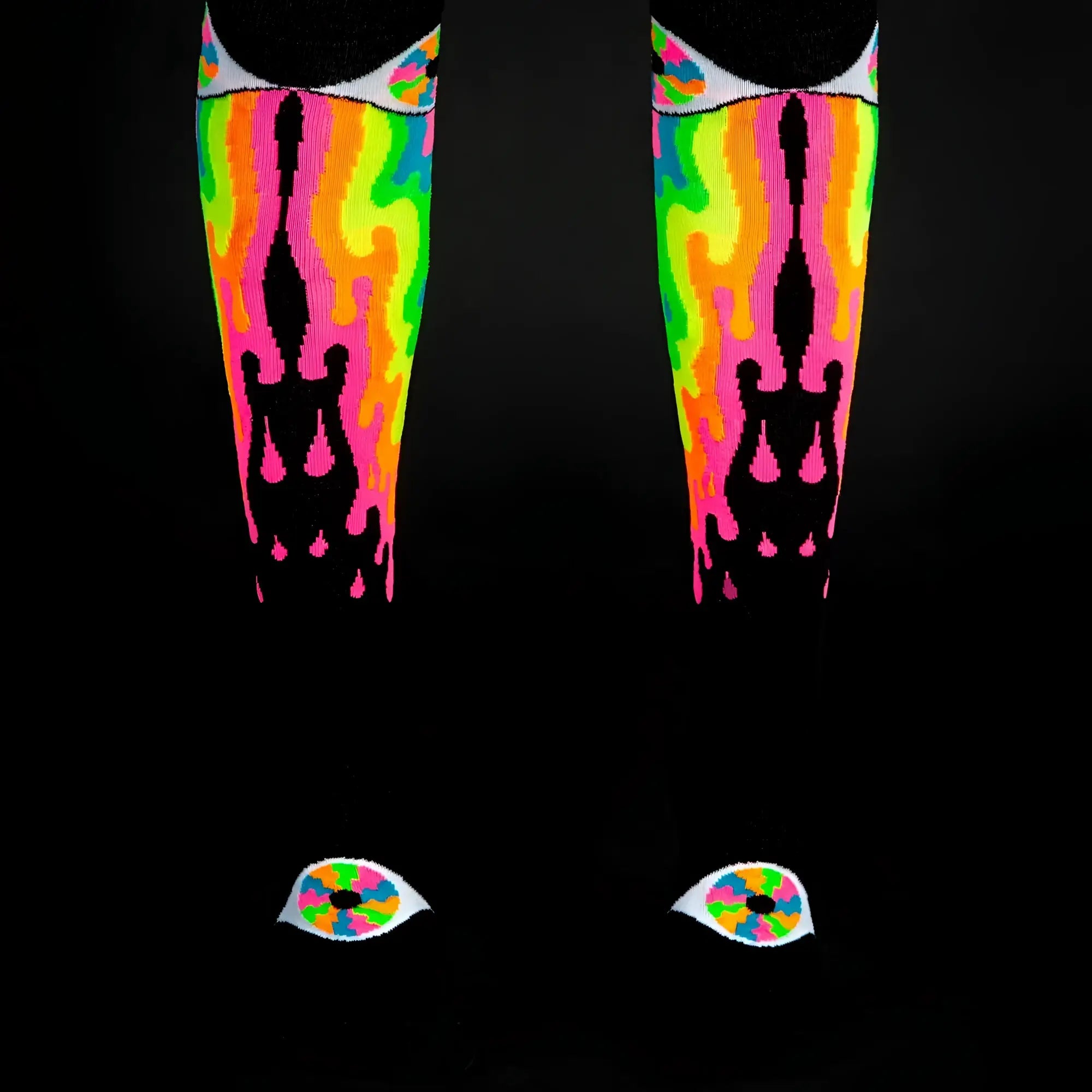 Psychedelic eye knee high socks featuring neon-colored flame patterns with black silhouettes and eye motifs at the toes