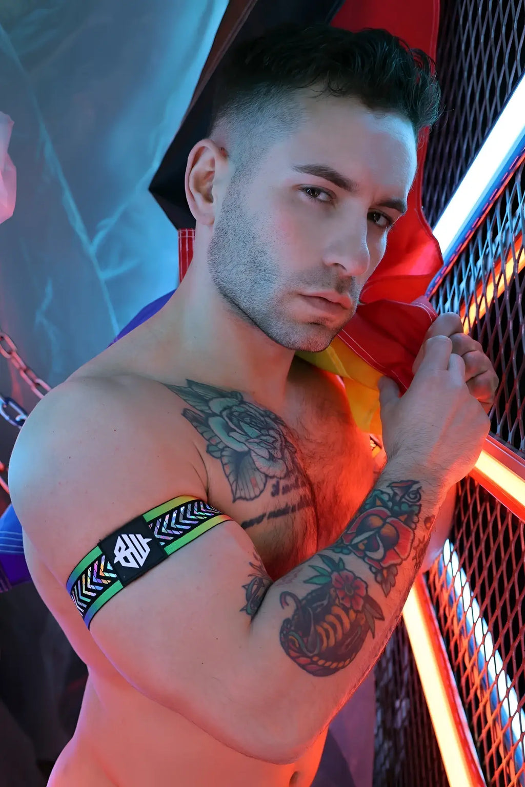 Black and green patterned pure pride armband with a white logo made from elastic material for sports use