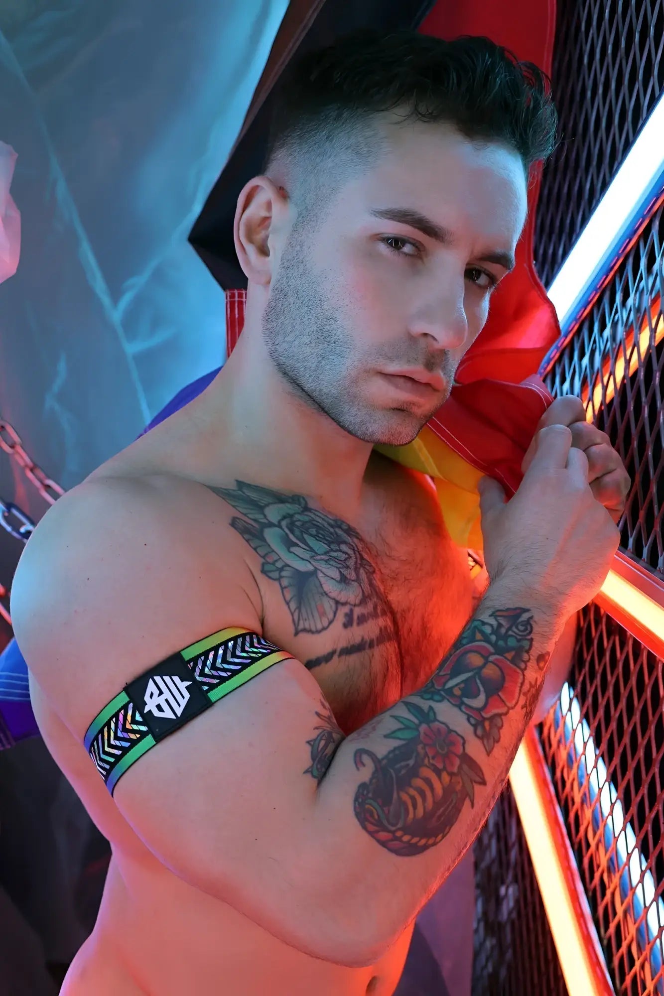 Black and green patterned pure pride armband with a white logo made from elastic material for sports use