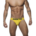 Yellow mesh push-up jockstrap briefs with black addicted branding on waistband showing the front side