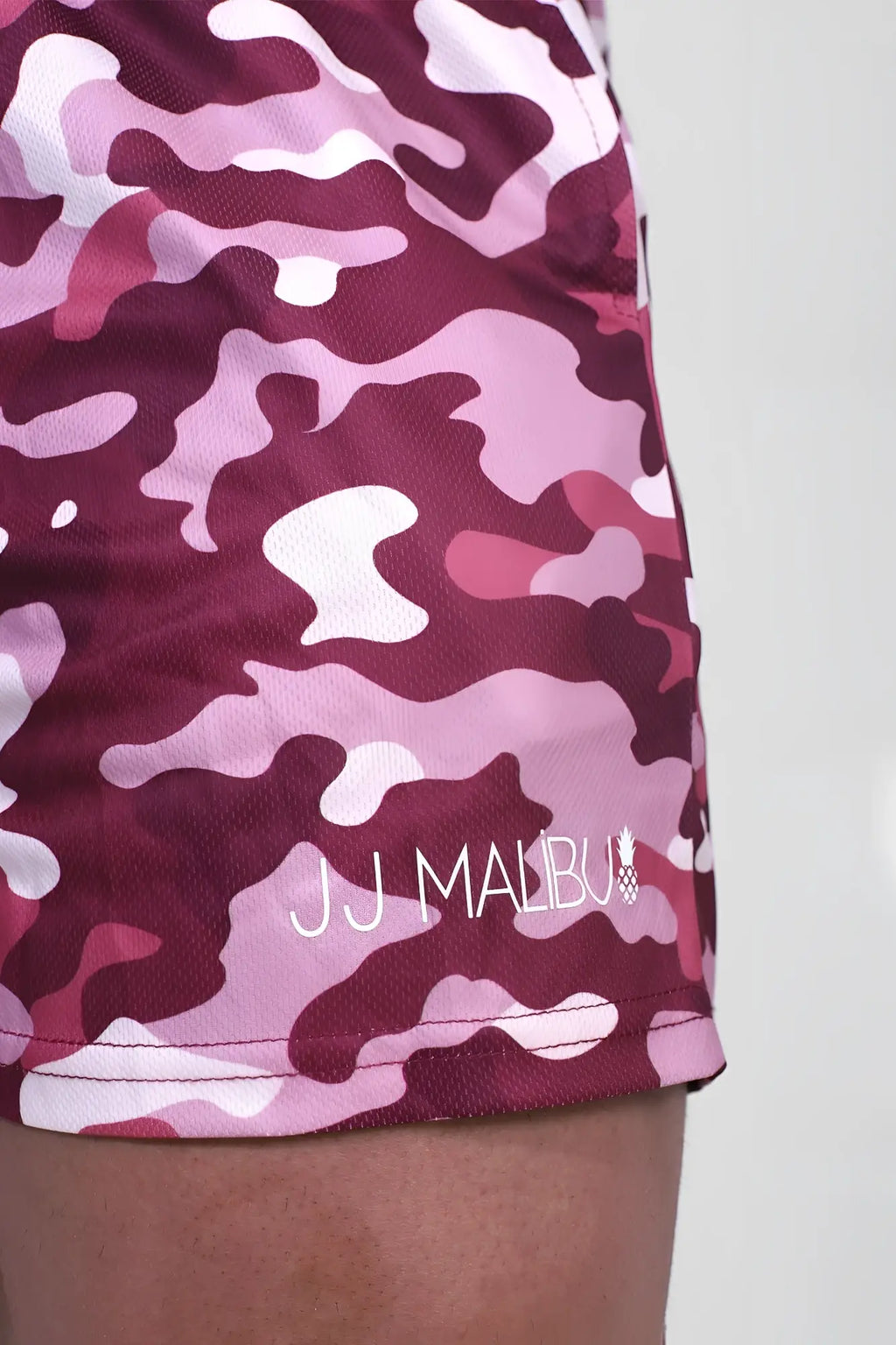 Quick-dry mesh shorts in purple camo with maroon and pink pattern and white jj malibu logo embroidered on lower leg