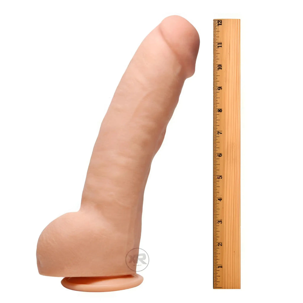 Raging Cockstars Annihilating Alexander: 10" realistic, flesh-toned dual-density dildo next to a wooden ruler.