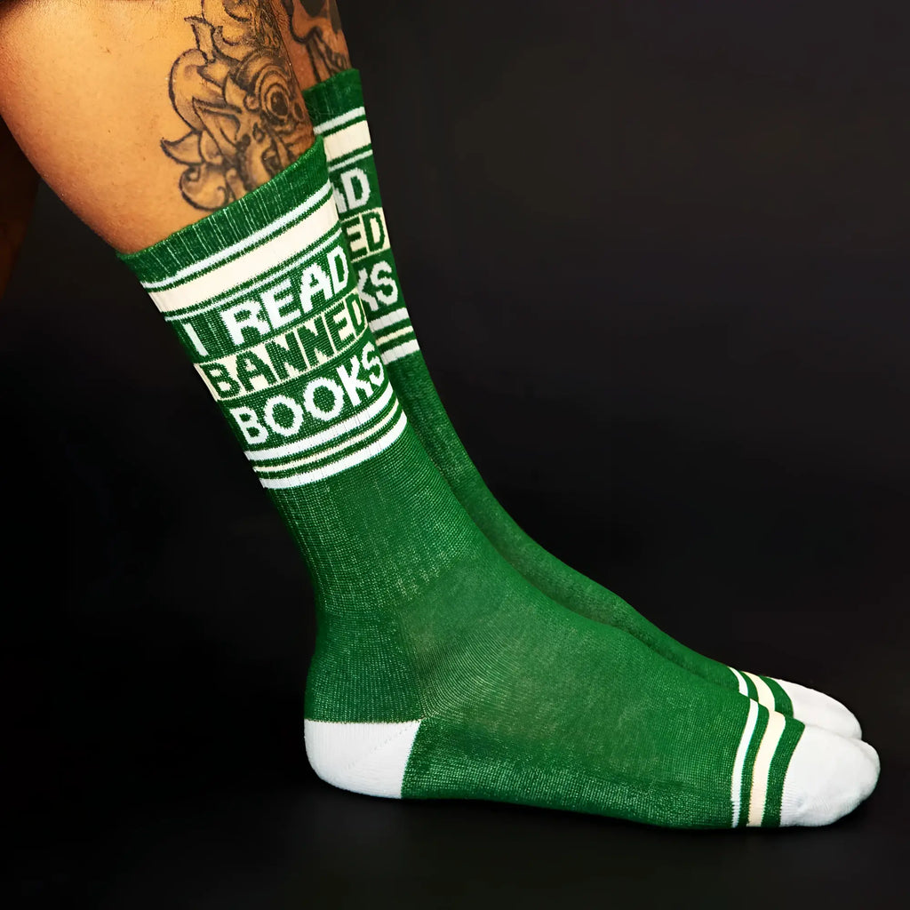 Green crew socks with white stripes and bold i read banned books text in textured knit material