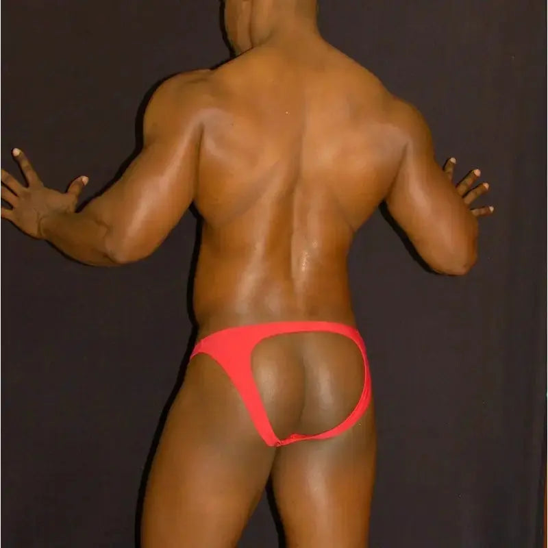 Red bikini jockstrap underwear by Arroyman featuring a minimal back design and elastic waistband shown on a model from the back.