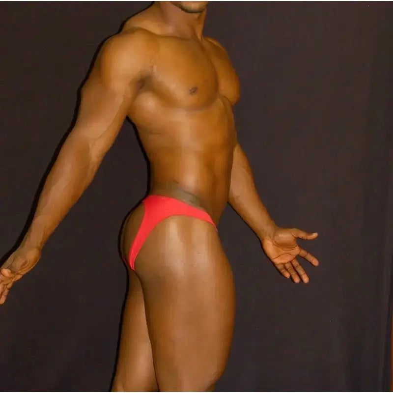 Red bikini jockstrap underwear by Arroyman featuring a minimal design and snug fit shown on a model from the side.