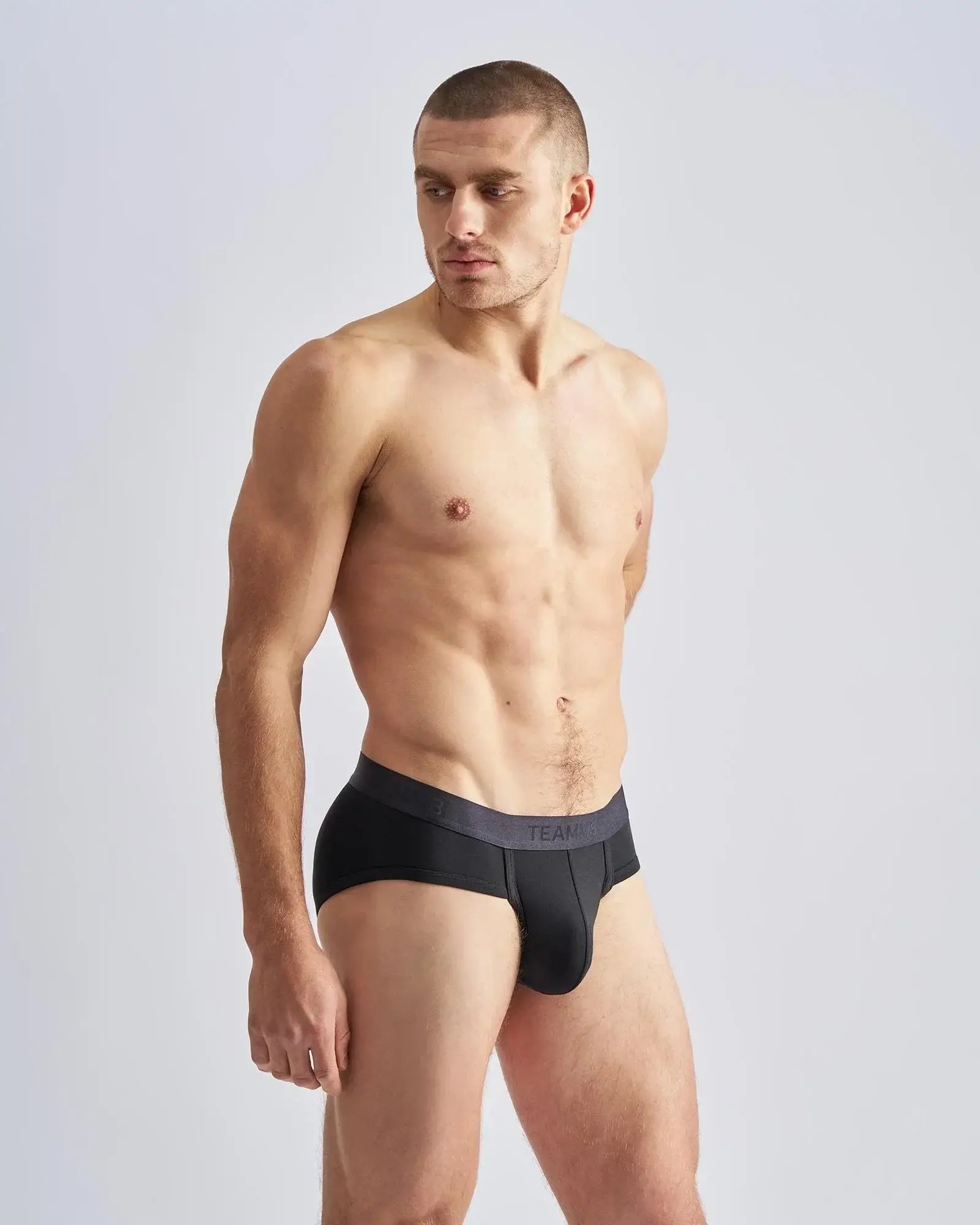 Black men’s briefs reign brief with dark gray waistband featuring team branding in white lettering front view