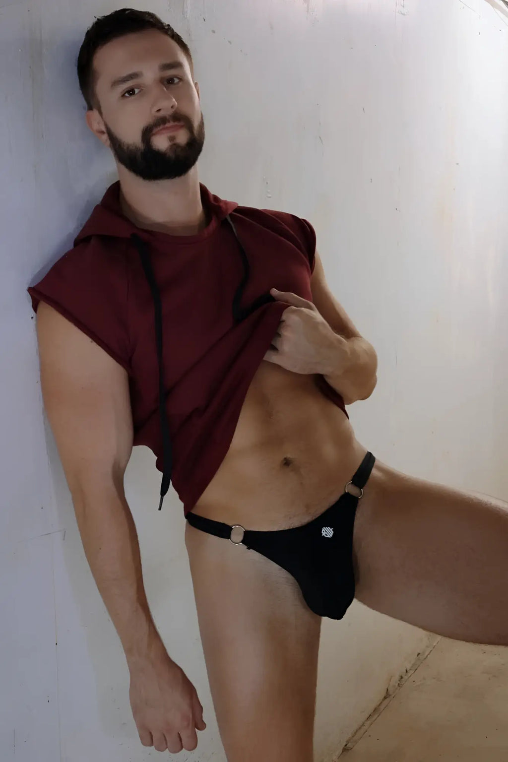 Black thong with silver buckle and diamond-shaped embellishment in renegade raw hoodie product image