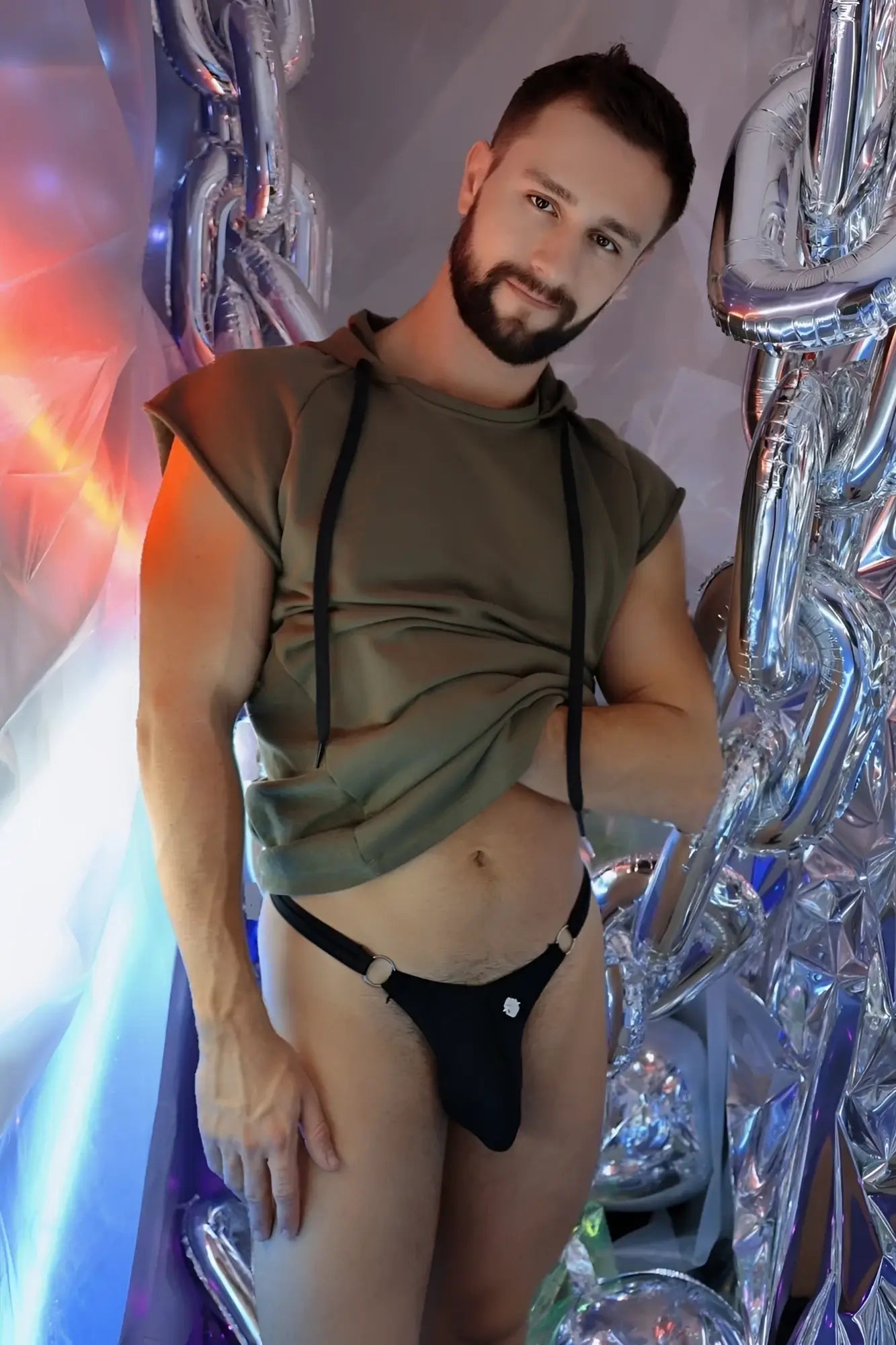 Black thong with silver grommets featuring raw edge details for edgy streetwear looks