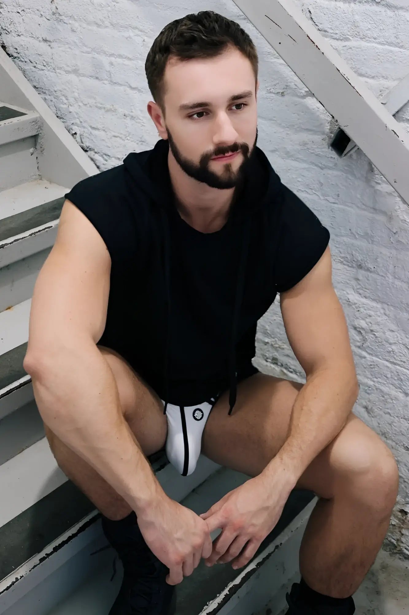 Black and white athletic briefs with circular logo on front designed for comfort and performance in renegade raw hoodie style