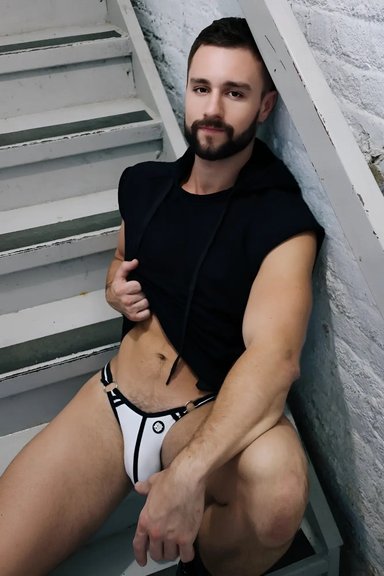 White and black athletic briefs with circular logo on front designed for active wear in renegade raw hoodie collection