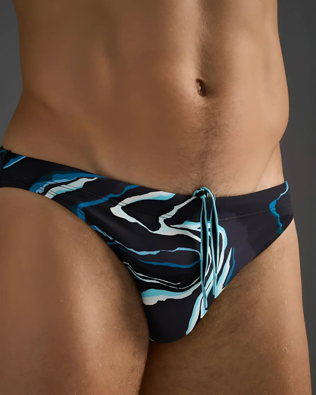 Dark blue resort bikini swim brief with dynamic lighter blue and white swirl pattern and matching drawstrings