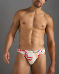 White swim trunks with vibrant red blue and beige abstract swirl pattern from resort bikini swim brief collection