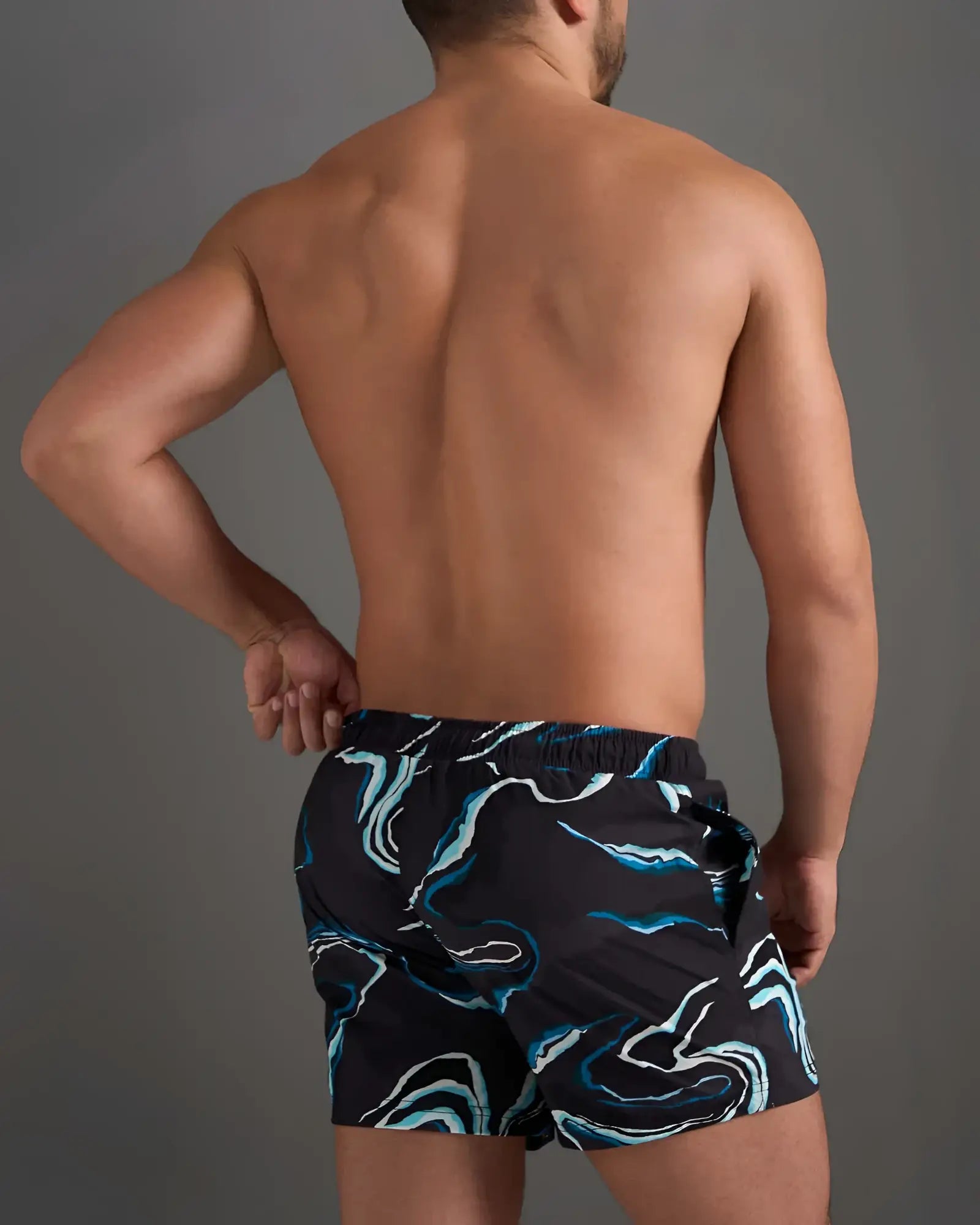 Resort swim short black swim trunks with a dynamic blue and white swirling pattern for beach and pool use