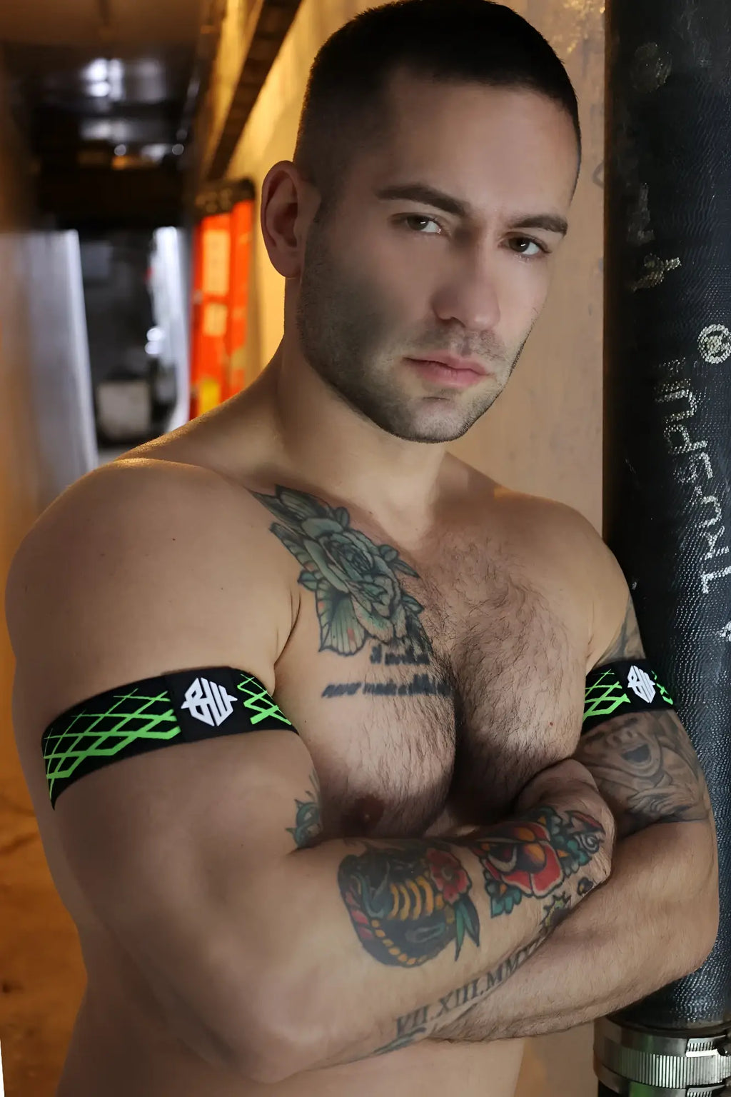 Black and neon green patterned revolution armband with geometric design for fitness and sports use