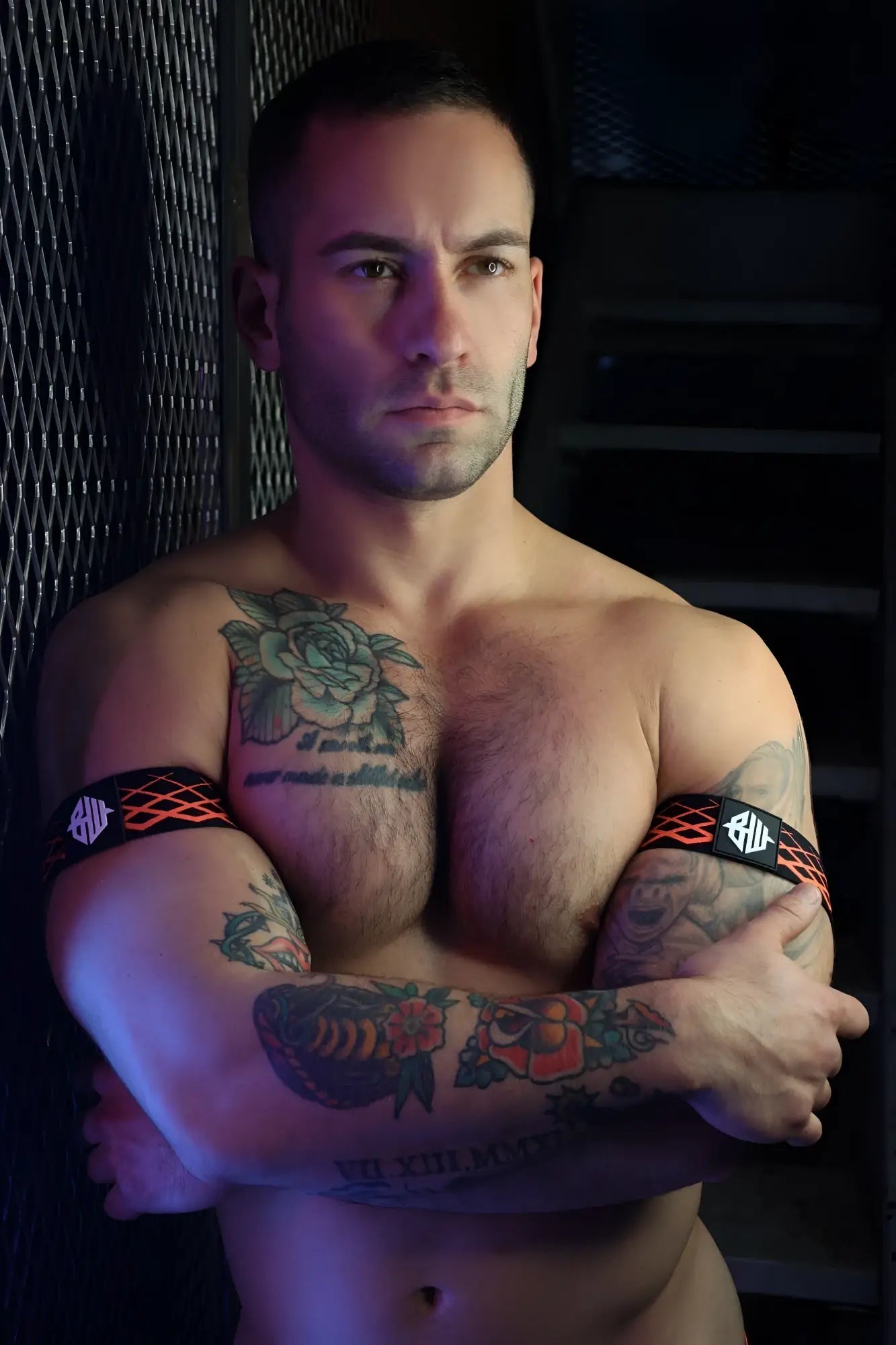 Black and orange patterned revolution armbands with white logo designed for athletic use and stylish wear