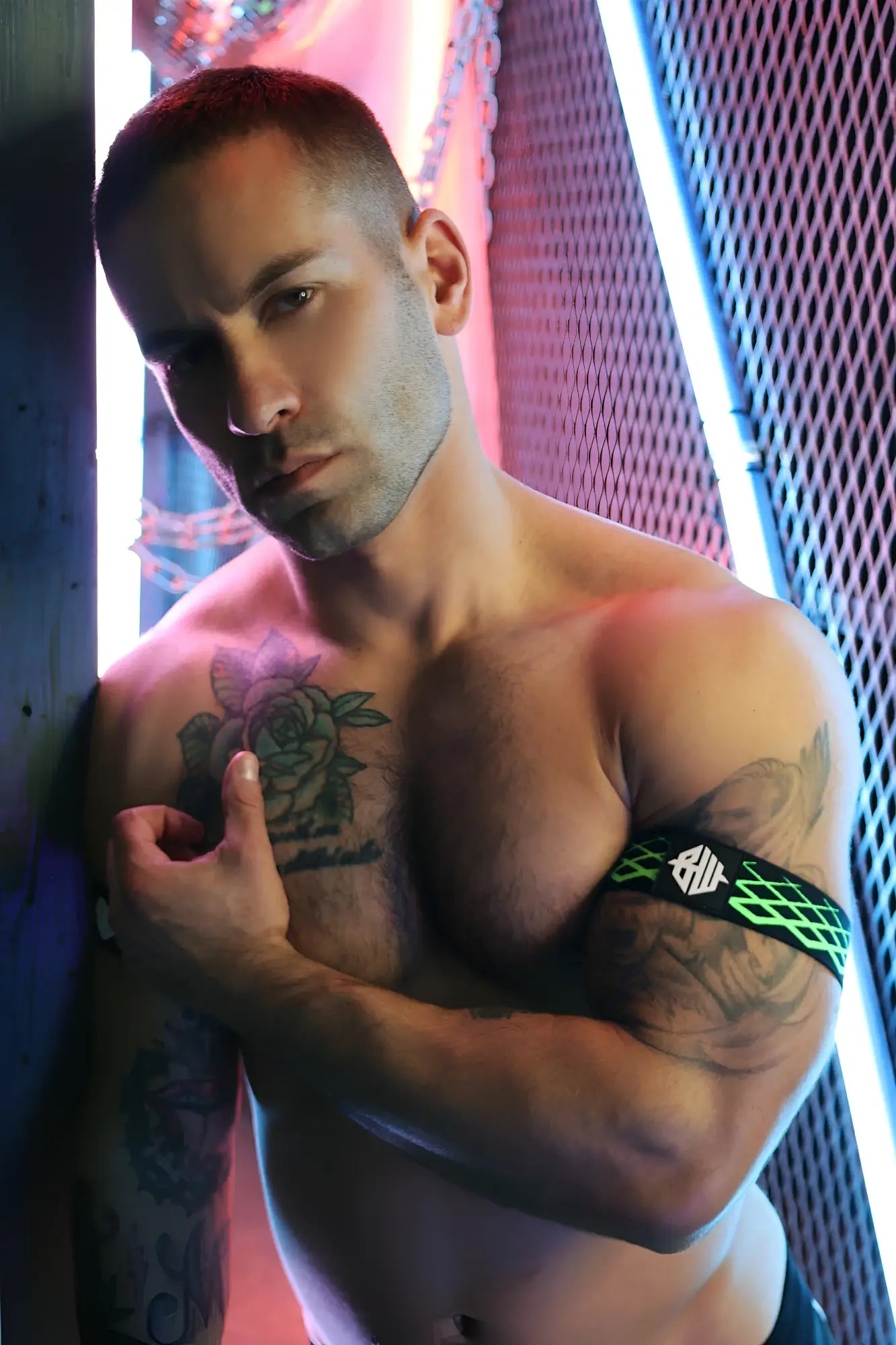 Green and black patterned Revolution armband featuring a geometric logo designed for active use