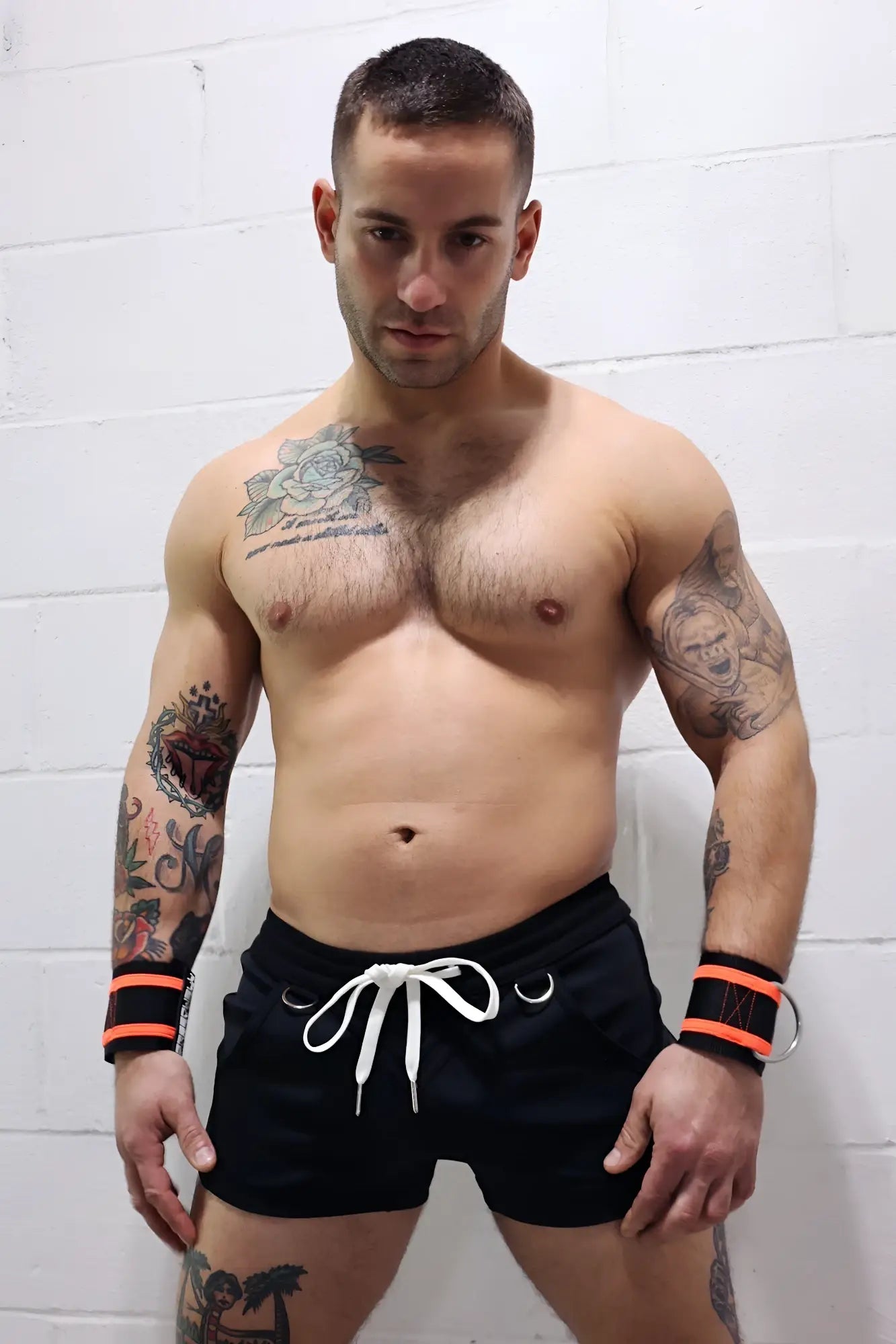 Black Revolution athletic shorts with white drawstring and orange waistband trim made for performance and comfort