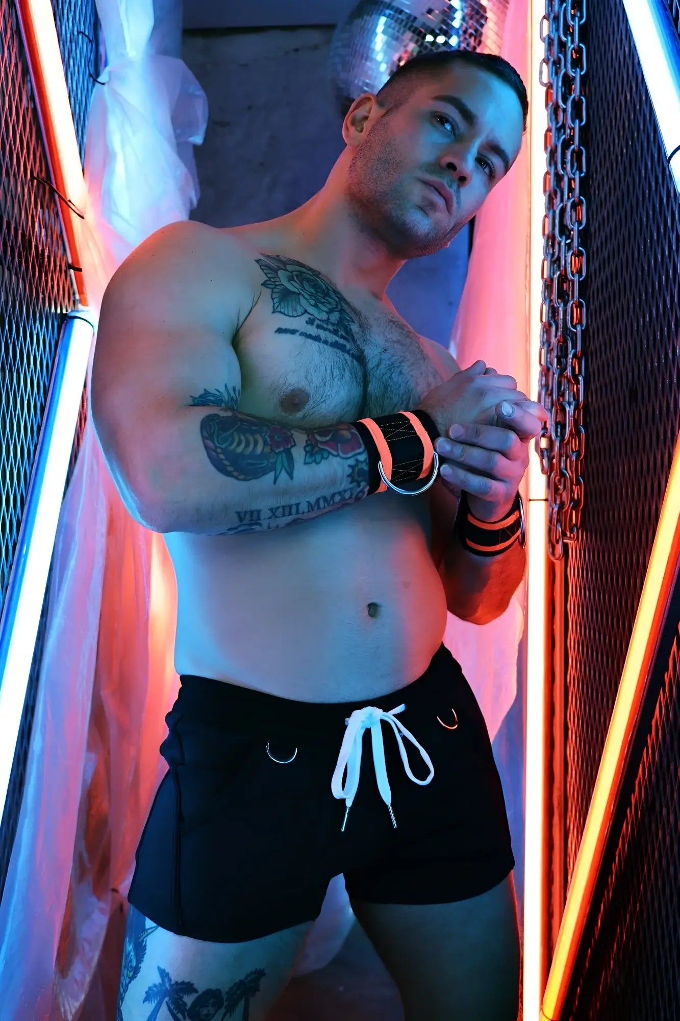 Black Revolution shorts with white drawstring and silver metal rings on the sides for athletic use