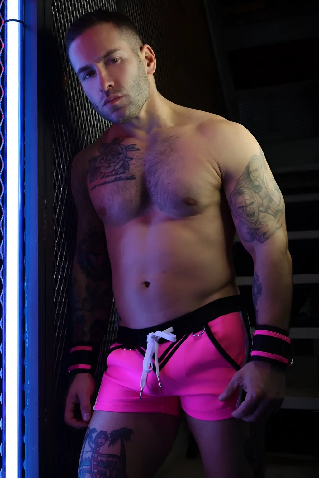 Bright pink revolution shorts with black trim and white drawstring waistband for casual or athletic wear