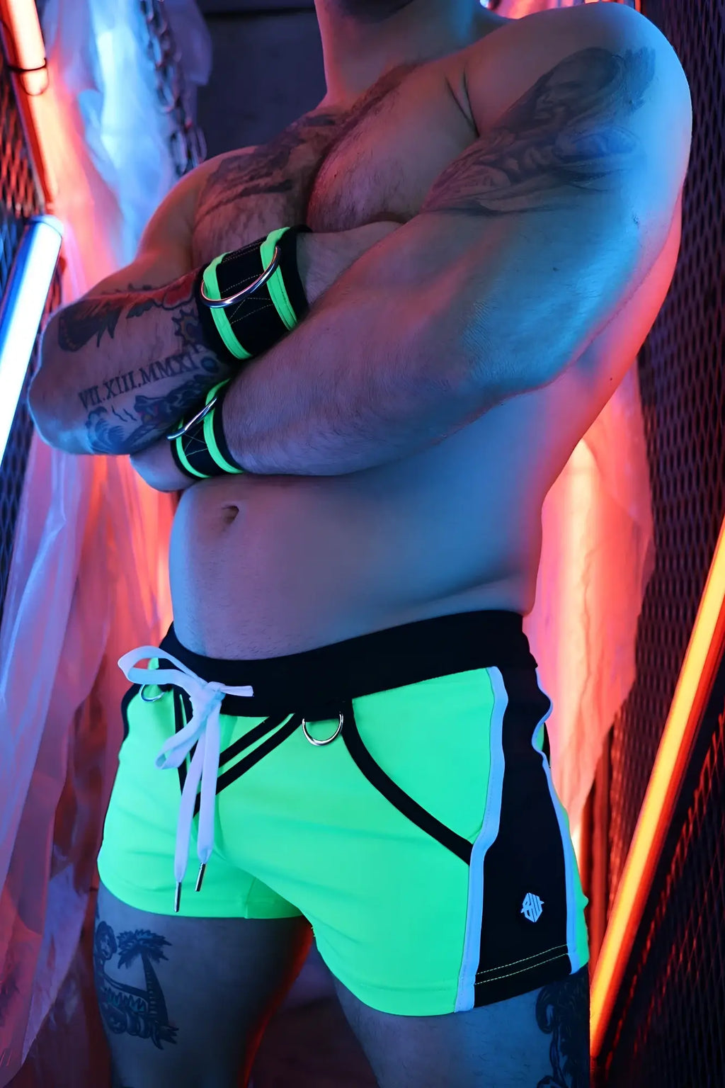 Neon green revolution shorts with black side panels white drawstring and small logo on the lower right leg