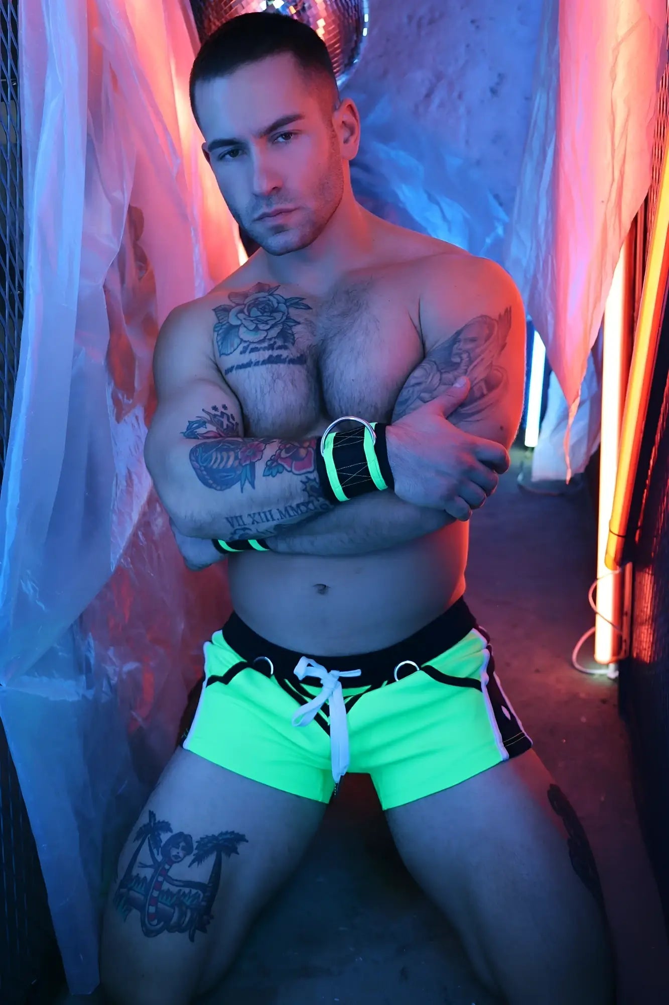Neon green revolution shorts with black trim and white drawstring waistband designed for athletic use