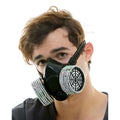 Black gas mask adorned with sparkling silver rhinestones around filter housings in rhinestone gas mask design