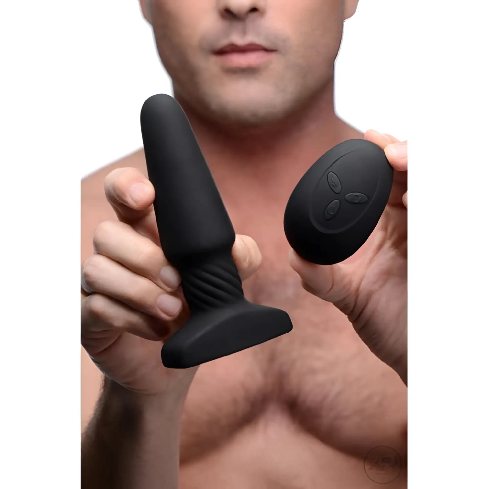 A person holding the black matte Rimmers Slim R Rimming Plug with its matching remote control.