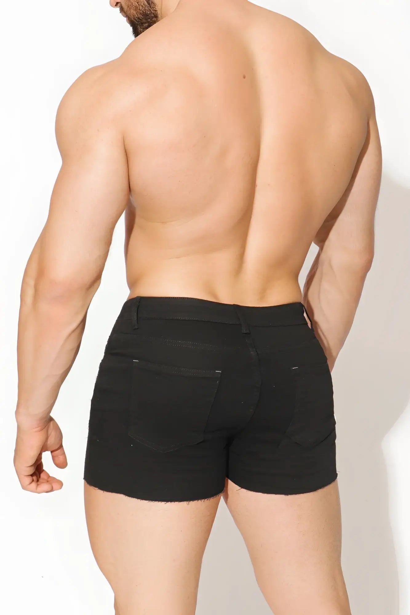 Black denim Rockstar Raw Cut 2.5 inch shorts with classic five-pocket design and frayed hem