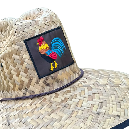 A woven lifeguard straw hat with a colorful embroidered rooster patch on the front